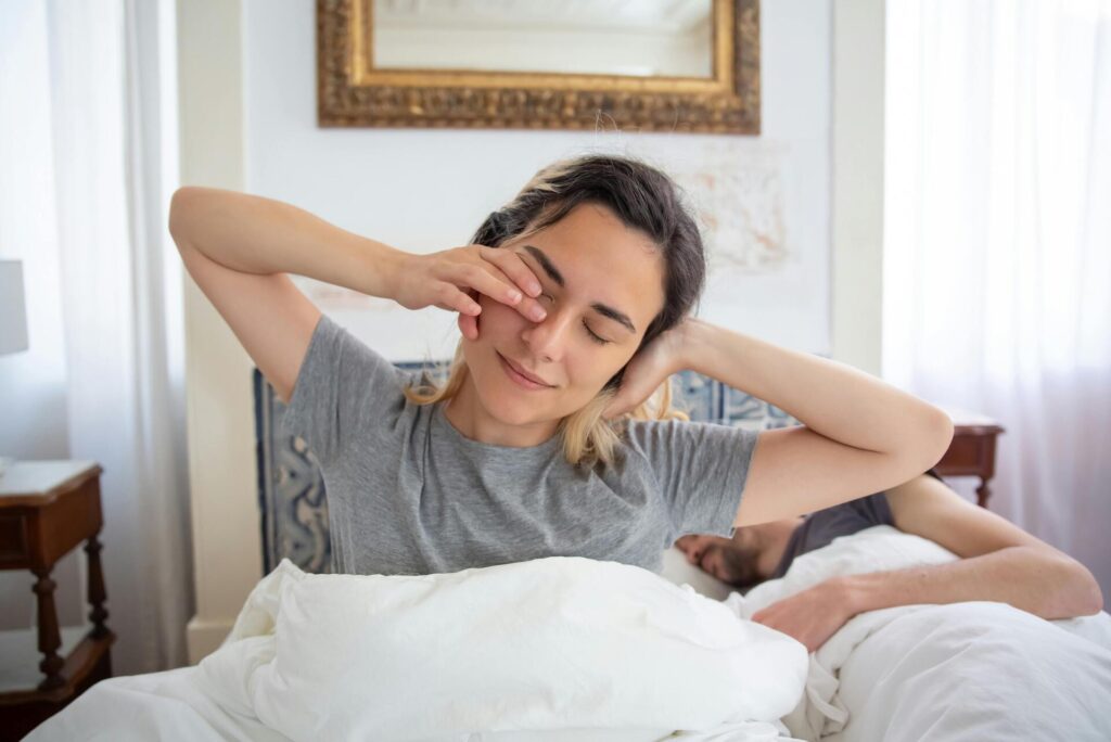 woman waking up tired even after 8 hours of sleep
