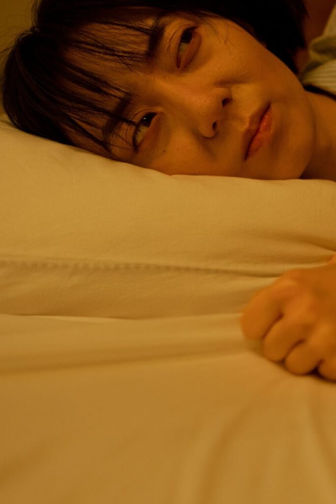 Woman lyingi n bed and can`t fall back asleep