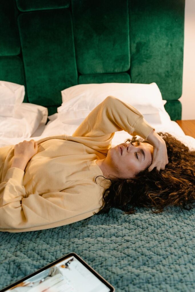 woman lying in bed asking why do i wake up feeling shaky 